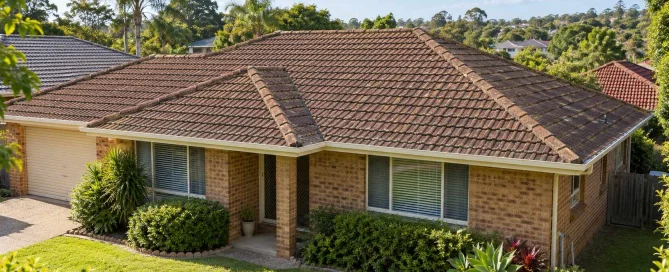Illustration of a brick home with an ageing brown tiled roof, surrounded by greenery.